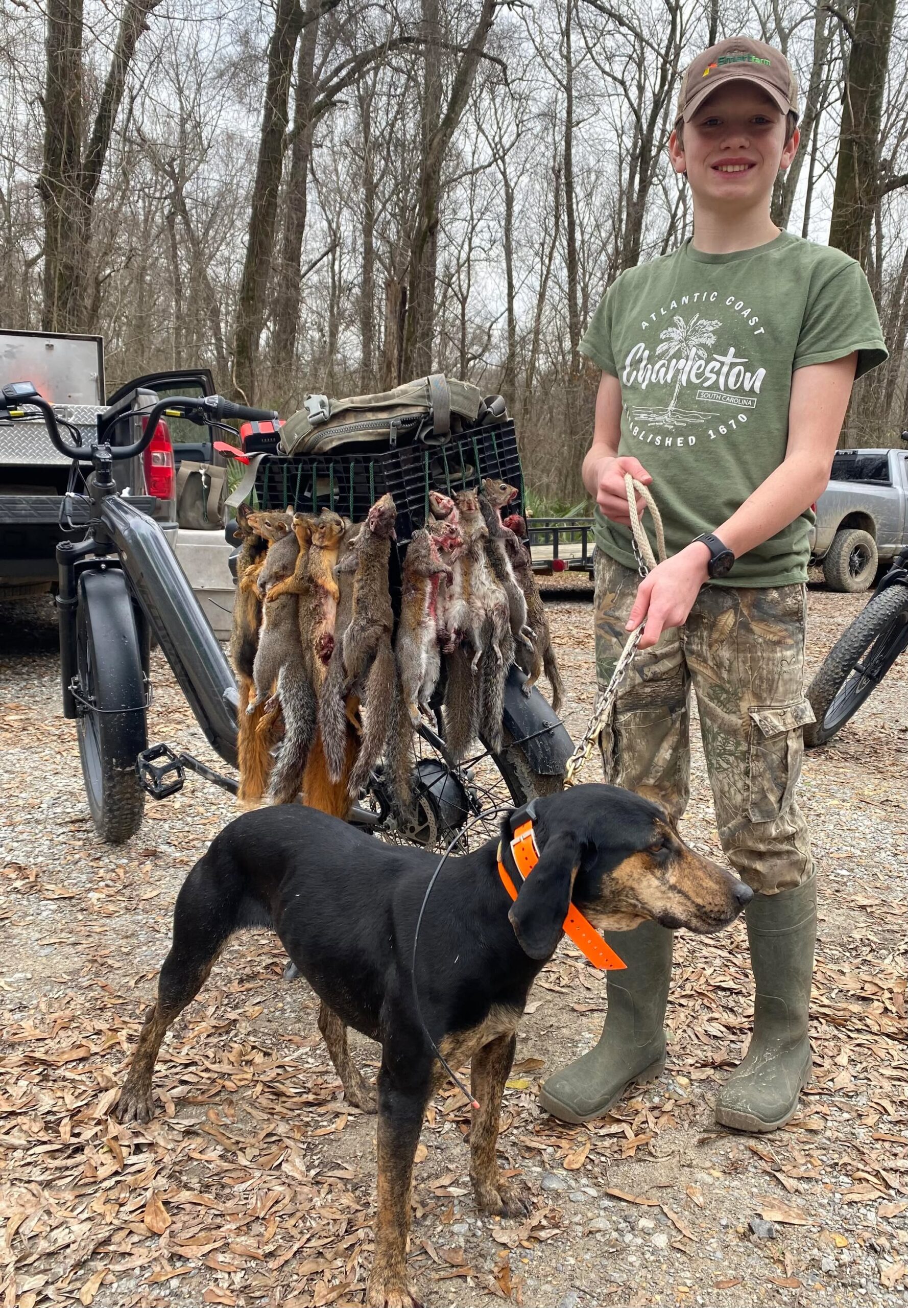 Young hunter with squirrel dog and ebike