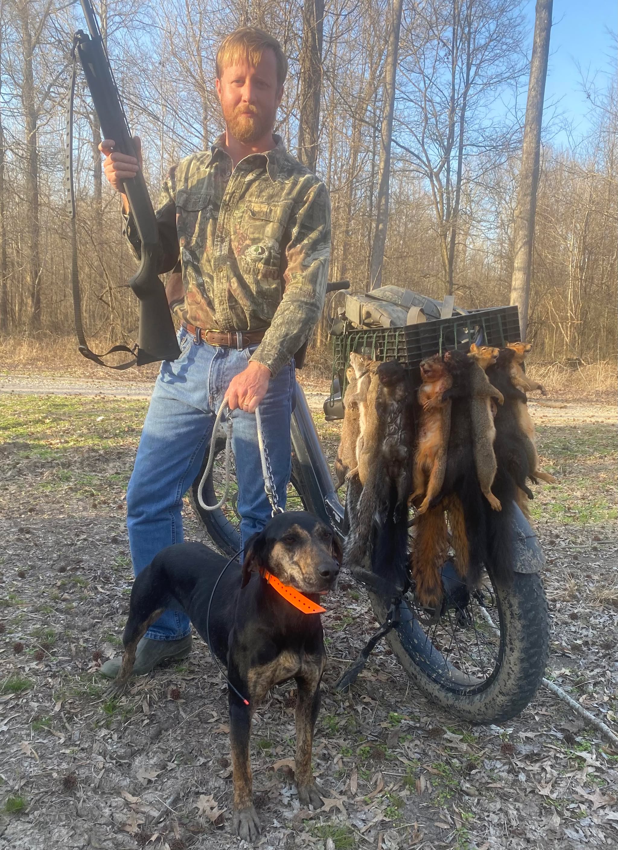 Hunter with squirrel dog and harvest on ebike