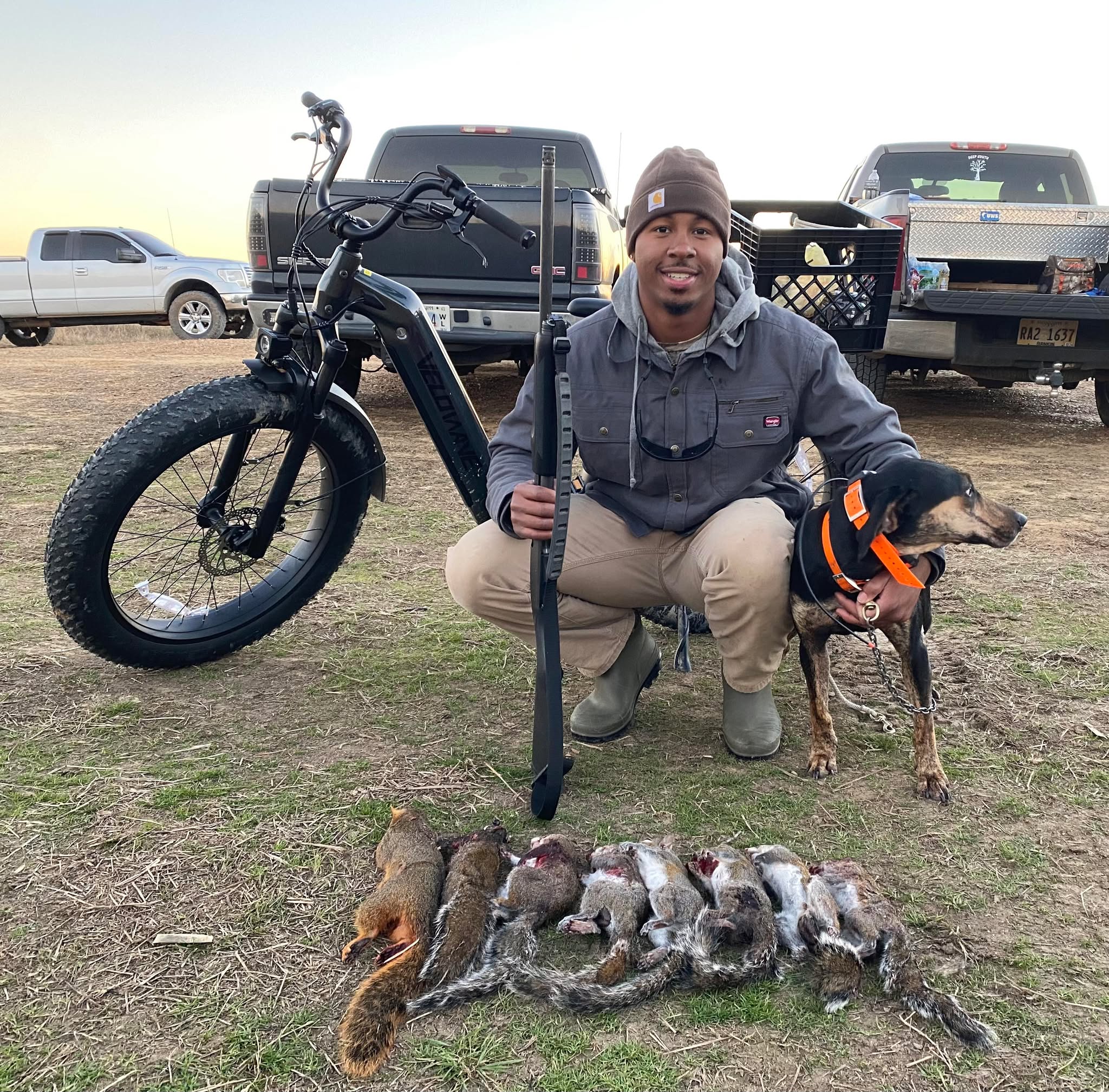Hunter with squirrel dog and ebike at parking area