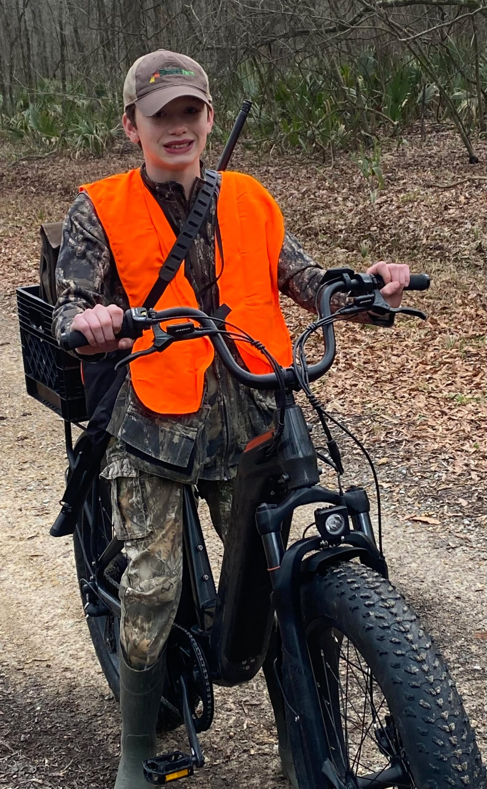 Young hunter in blaze orange on ebike